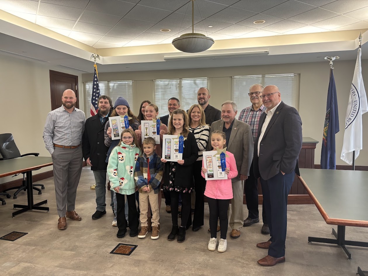 Picture of the bookmark contest winners with their families and ocunty commissioners